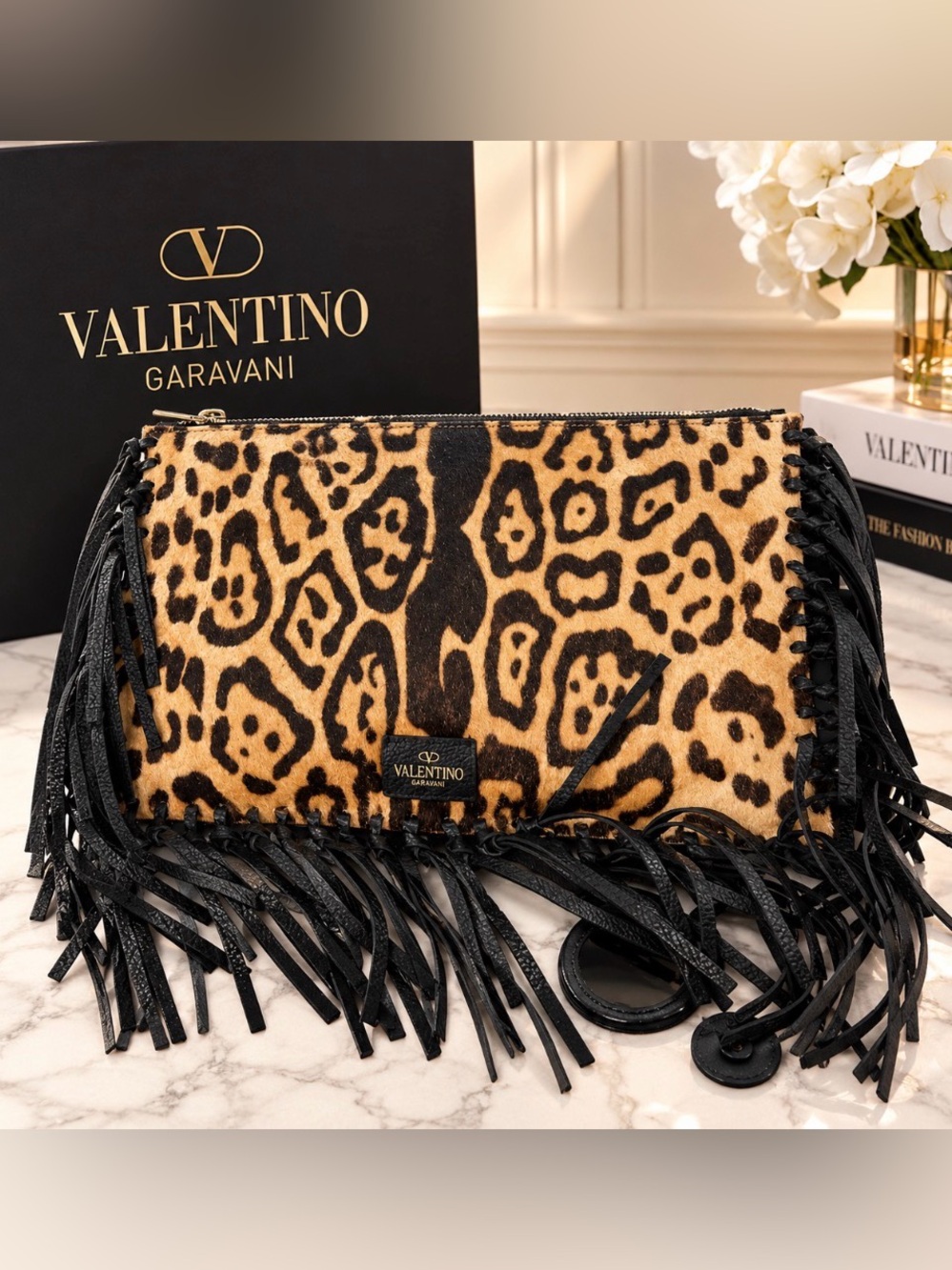 Valentino Garavani Calf Hair Oversized Fringe Clutch.